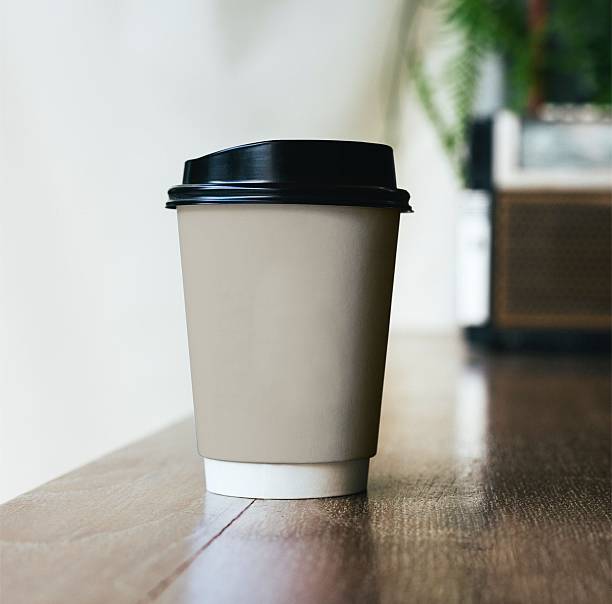 istock Disposable Coffee Cup on Wooden Surface in Modern Setting 2210796644
