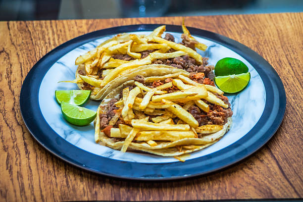 Mexican beef jerky tacos with fries on top and lemons on the side, tacos from Mexico City and Mexico State, edomex