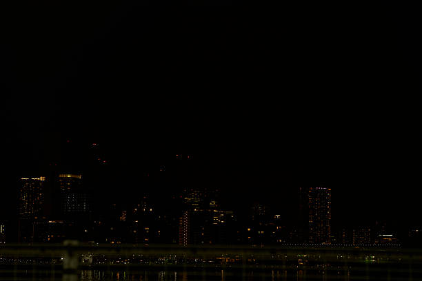 The hustle and bustle of the city seems like something from the distant past, and now only a deep silence dominates the surroundings. The veil of night hangs heavy, obscuring even the outline of the city. In the midst of it all, the barely visible light is like a soul lost in the darkness. What kind of story is hidden in the depths of this silence?