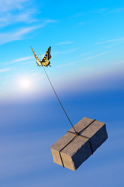 istock Butterfly lifting stone – Strength and resilience concept 2210798130