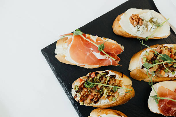 istock Delicious appetizers served on a black slate platter at a gathering 2210800339