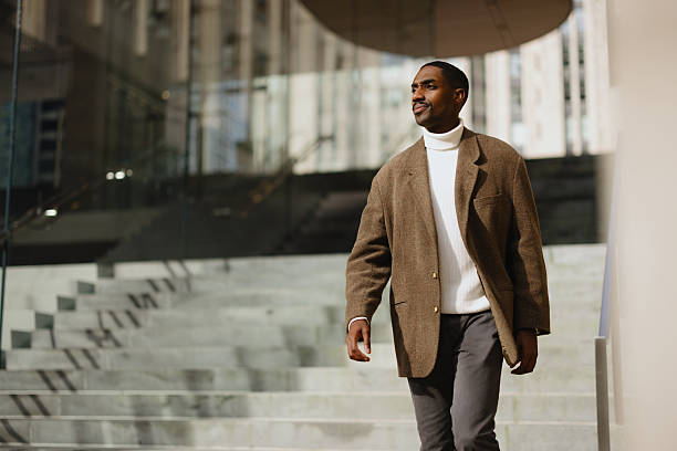 istock Confident Man in Formal Attire Walking Down Urban Stairs 2210800720