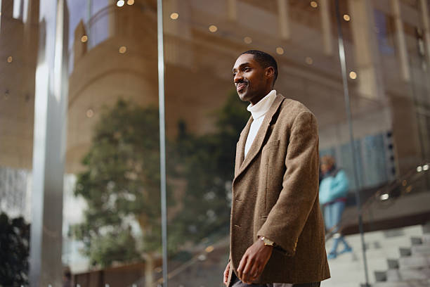 istock Stylish Individual in Trendy Outfit Walking Through Modern Urban Setting 2210800732