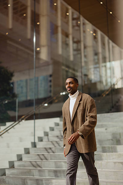 istock Confident Businessman Walking Outdoors by Modern Glass Building 2210800733