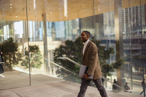 istock Professionally Dressed Individual Walking With Confidence in a Modern Glass Building 2210800804