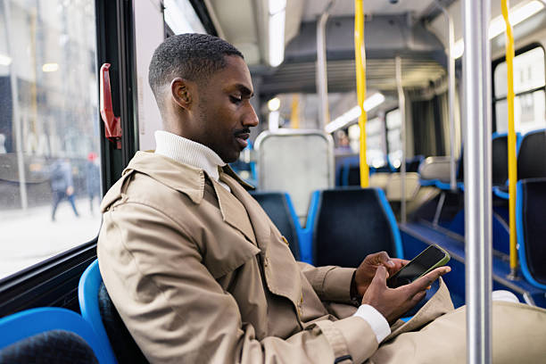 istock Man Sitting on a Bus Using a Smartphone During Daytime 2210800857