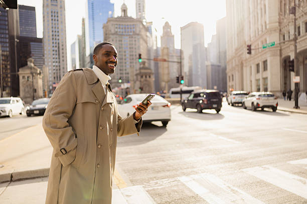 istock Smiling Man in Urban Setting Holding Phone Under Soft Evening Light 2210800870
