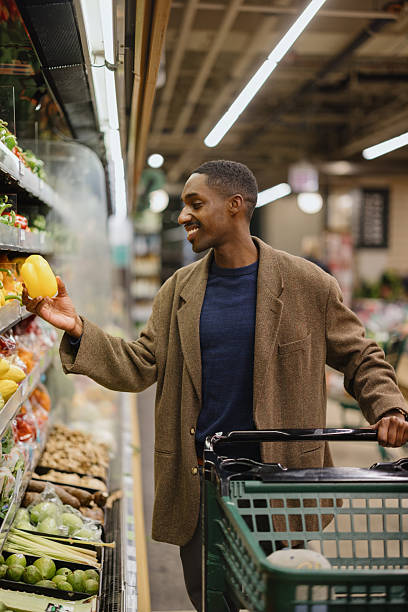 istock Man Shopping for Fresh Vegetables at a Grocery Store 2210800917