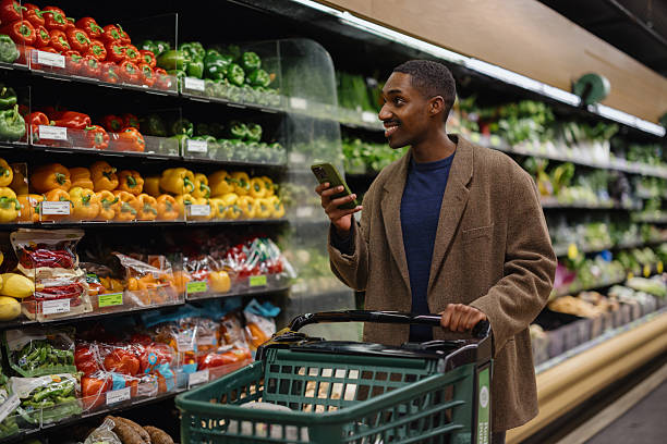 istock Man Shopping for Fresh Vegetables at a Grocery Store 2210800919
