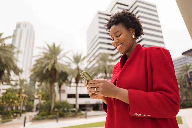 istock Professional Woman Smiling And Using Smartphone Outdoors In Modern Cityscape 2210800929