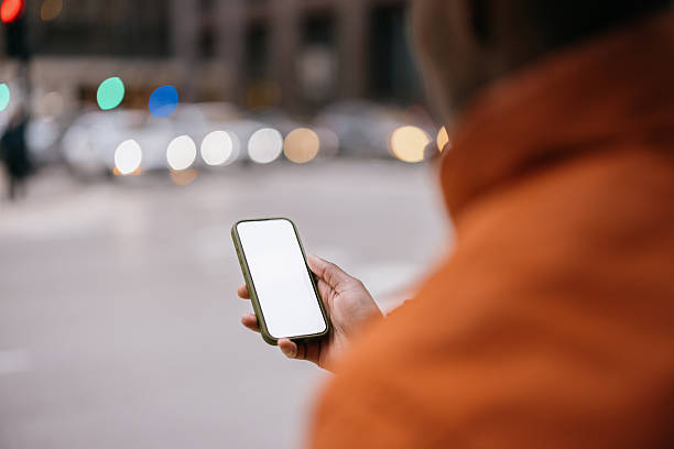 istock Person Using Smartphone on City Street With Blurred Background Lights 2210800930