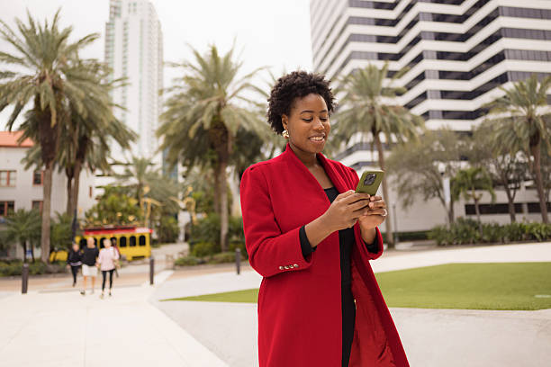 istock Urban Professional Using Smartphone in City Center with Palm Trees 2210800938