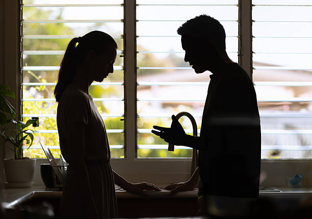 istock Silhouette of couple at home discussing problems relationship issues. 2210803730