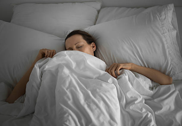 istock Young woman sleeping in bed, 2210803783