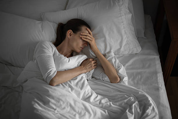 istock Sick woman laying down in the bed. 2210803809