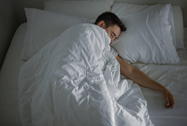 istock Young man in a peaceful sleep. 2210803827