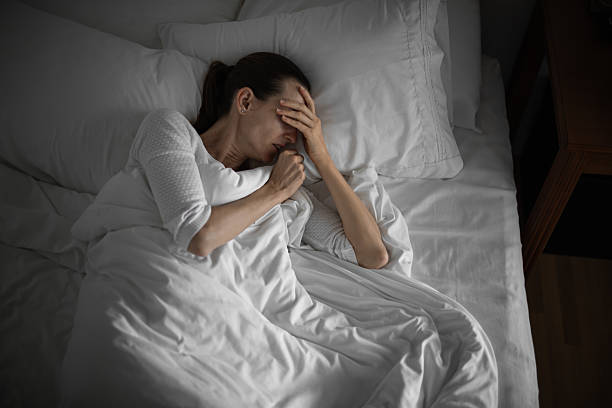 istock Sick woman in bed coughing 2210803828