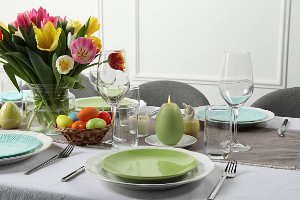 istock Easter celebration. Festive table setting with beautiful flowers and painted eggs 2210804881