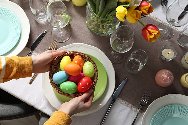 istock Woman setting table for festive Easter dinner at home, top view 2210804884