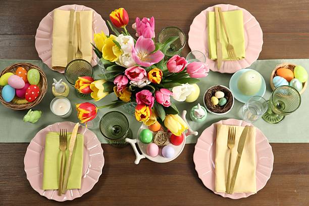 istock Easter celebration. Festive table setting with beautiful flowers and painted eggs, flat lay 2210804893