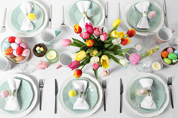 istock Easter celebration. Festive table setting with beautiful flowers and painted eggs, flat lay 2210804894