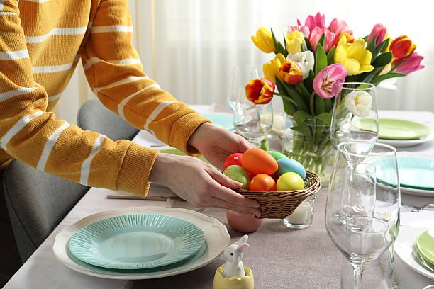 istock Woman setting table for festive Easter dinner at home, closeup 2210804927