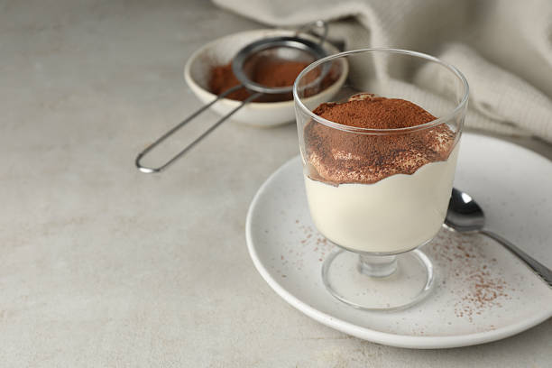 istock Delicious tiramisu in glass on light table. Space for text 2210804948