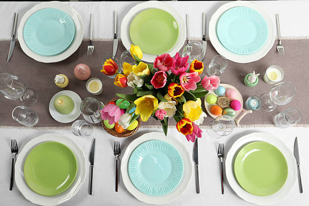 istock Easter celebration. Festive table setting with beautiful flowers and painted eggs, flat lay 2210804975