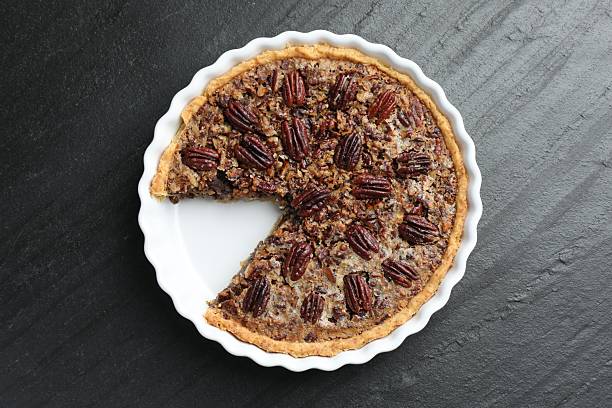 istock Delicious pecan pie in baking dish on dark gray textured table, top view 2210805054