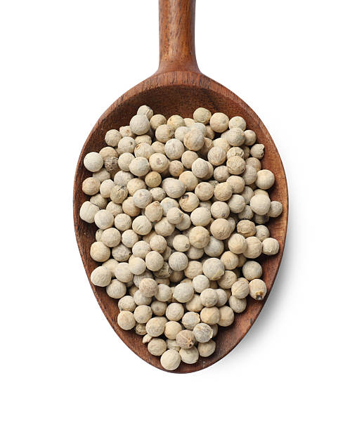 istock Aromatic spice. Many peppercorns in spoon isolated on white, top view 2210806857