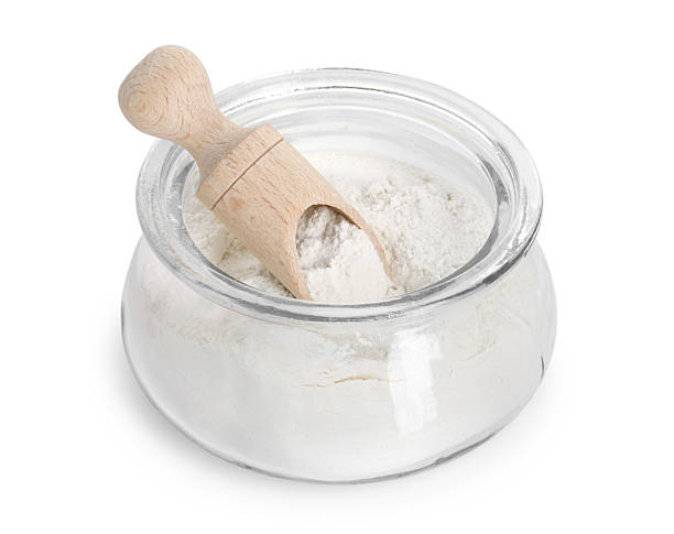 istock Baking powder in glass jar and scoop isolated on white 2210806903