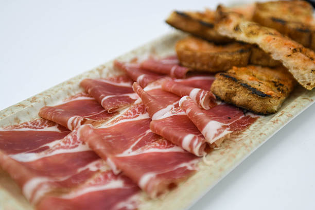 Slicing acorn-fed Iberian ham with a knife