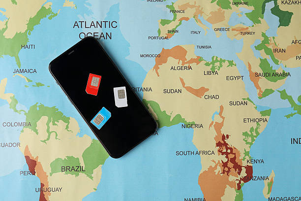 istock SIM cards and smartphone on world map, flat lay 2210807448