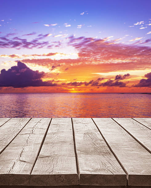 istock Empty wooden table top with tropical ocean sunset background 2210810284