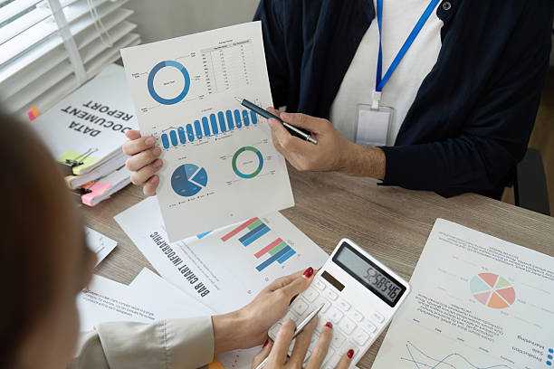 istock Professional reviewing financial data with a calculator and reports. 2210813204