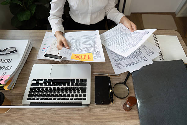 istock Accountant preparing tax documents and organizing financial papers 2210813342