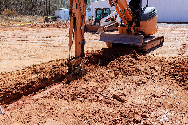 istock Excavator digging a trench on a construction site in a rural area during daylight hours 2210813578