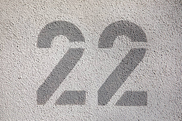 istock house number 22 in grey at a white wall 2210814033