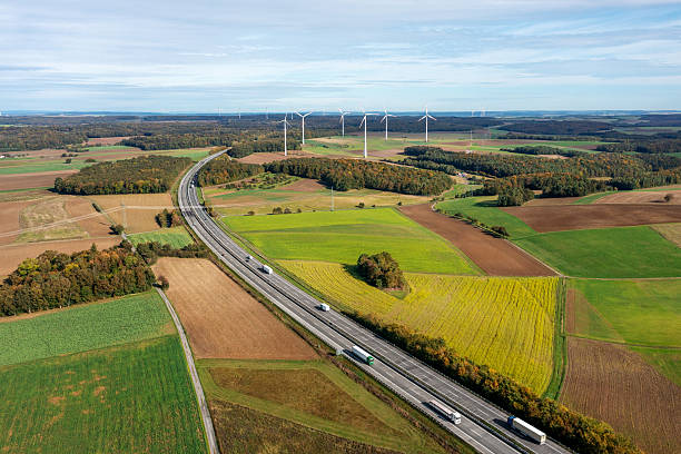 istock Drone shot with german highway and wind turbines in autumn scenery 2210814280