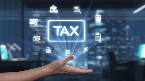 istock Conceptual representation of tax-related services in a modern office environment with digital icons symbolizing finance and accounting processes. Auvana 2210815708