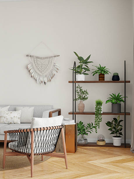 Scandinavian-style living room with a light gray sofa, white pillows, patterned cushions, wooden shelves with green plants, macrame wall hanging, and a woven pendant light. Neutral tones and natural materials create a cozy ambiance.