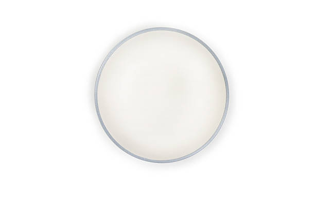 istock The top view is a white ceramic round bowl with a light blue rim isolated on a white background. 2210819794