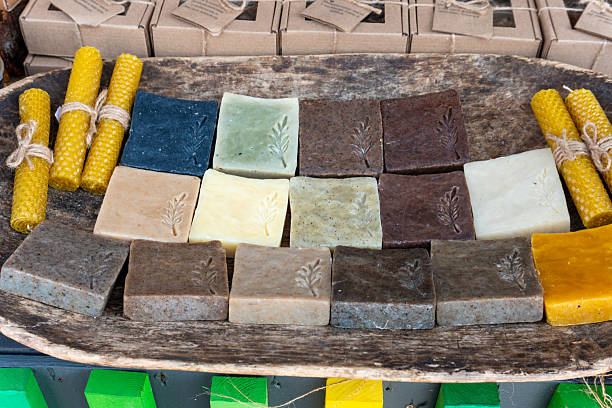 Bars of handmade soap displayed on a market counter. Natural homemade soap for sale.