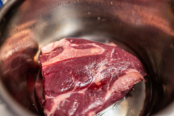 istock Chuck roast beef meat in kitchen saucepan pot for roasting, frying cooking and baking macro closeup cow traditional food 2210824852