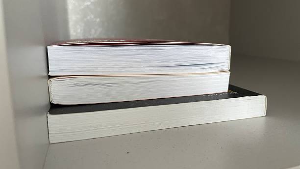 istock stack of books on the shelf in the library. close-up 2210825620