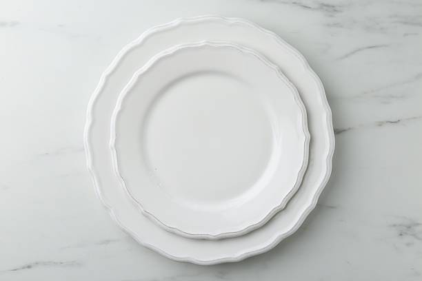 istock Stylish plates on white marble table, top view 2210826830