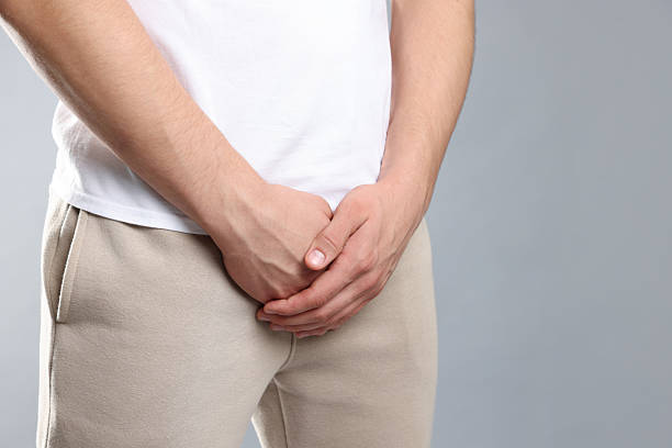 istock STD (sexually transmitted diseases). Man suffering from symptoms on grey background, closeup 2210828905
