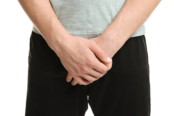 istock STD (sexually transmitted diseases). Man suffering from symptoms on white background, closeup 2210828923