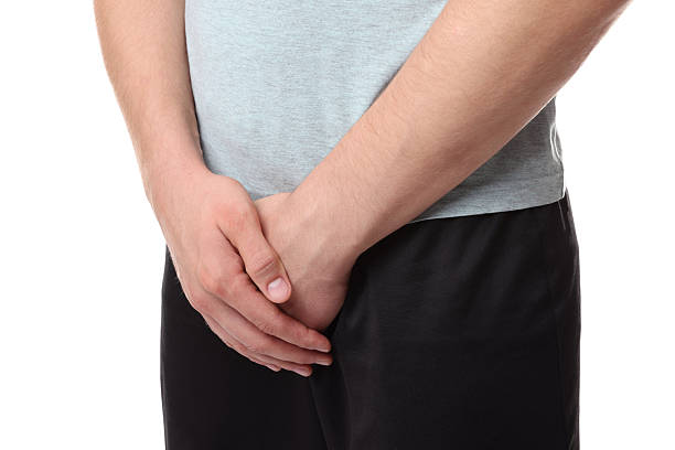istock STD (sexually transmitted diseases). Man suffering from symptoms on white background, closeup 2210828932