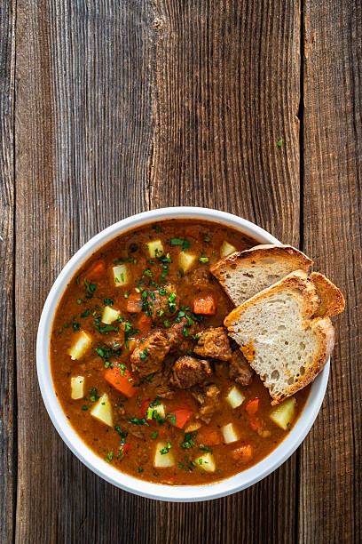 istock Beef stew with vegetables and potatoes on wooden table 2210830637